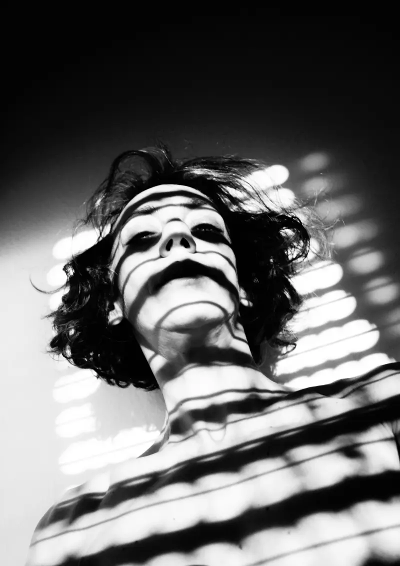 Gaze superior to the bars of shadow